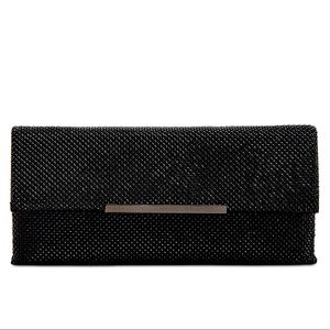 Shiny mesh clutch with removable chain strap. Black with back interior. By INC.
